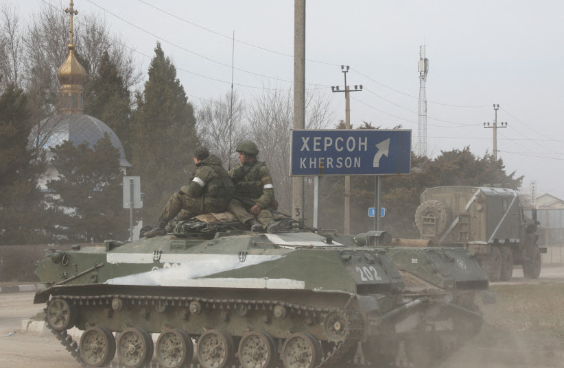  Servicemen ride on a Russian Army military armoured vehicle with the letter 'Z' on it, after Russian President Vladimir Putin authorized a military operation in eastern Ukraine, in the town of Armyansk, Crimea, February 24, 2022.  (credit: STRINGER/ REUTERS)