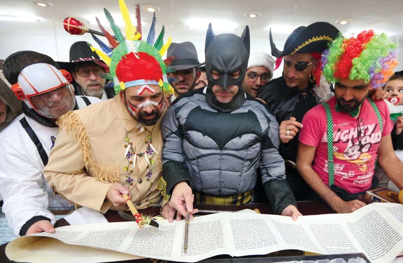  Men dressed as superheroes read from Megilat Esther at a synagogue in Jerusalem's Arnona neighborhood. (photo credit: MARC ISRAEL SELLEM)