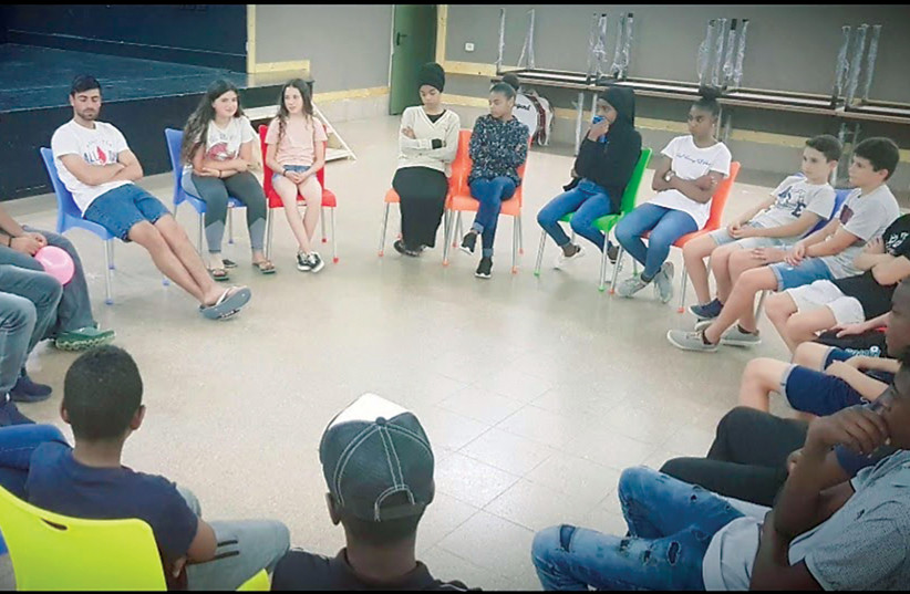  Jewish children from the Bnei Shimon Regional Council introduce themselves to Bedouin teens from Rahat at Rahat’s community center. (credit: RAMZI ALOBRA)