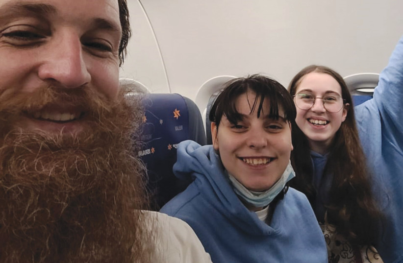  SHALIACH YOSSI GLICK with Risha (C) and Aviva on the flight to Israel. (photo credit: Glick family)