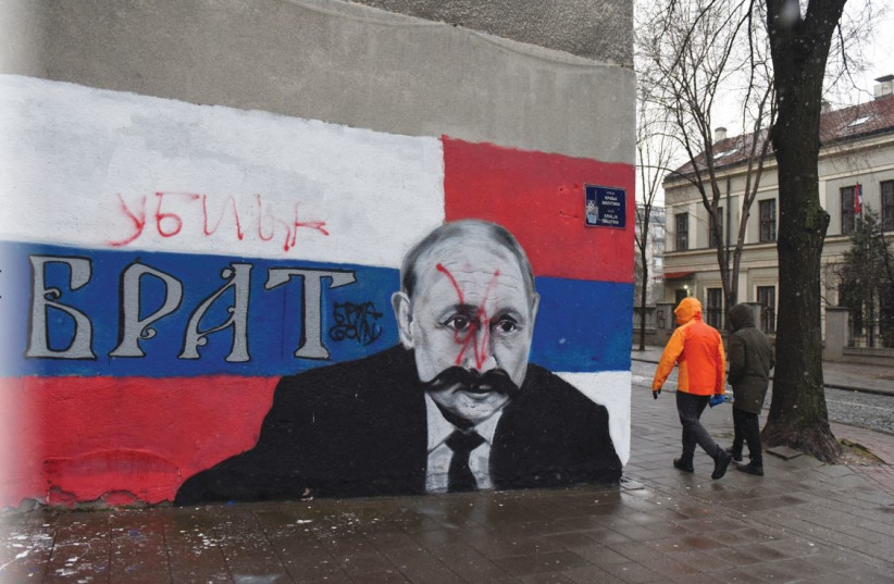  A MURAL of Russian President Vladmir Putin is vandalized – with red spraypaint and the word ‘Murderer’ written above the original text reading ‘Brother’ – in Belgrade, Serbia, March 6.  (photo credit: Zorana Jevtic/Reuters)