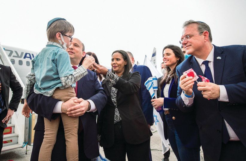  PRIME MINISTER Naftali Bennett and Aliyah and Integration Minister Pnina Tamano-Shata greet a young Ukrainian who arrived in Israel this week. (credit: NOGA MALSA)