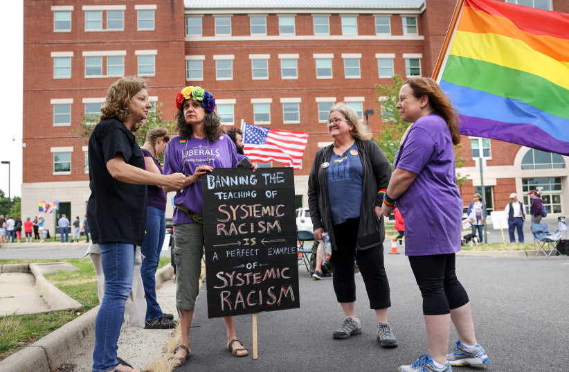  Supporters of the academic doctrine known as Critical Race Theory and transgender students meet outside the Loudoun County School Board headquarters before a school board meeting, in Ashburn, Virginia, US June 22, 2021.  (credit: REUTERS/EVELYN HOCKSTEIN)