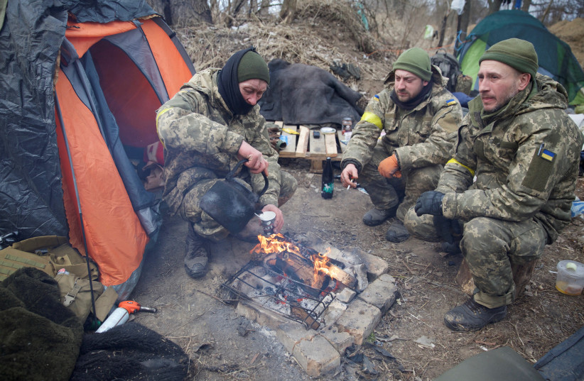  Members of the Ukrainian military sit, amid Russia's invasion in Ukraine, near Kyiv, Ukraine March 8, 2022. (credit: Anna Kudriavtseva/Reuters)