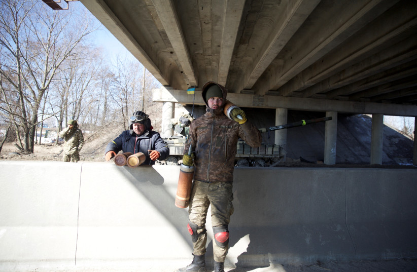  Members of the Ukrainian military are seen, amid Russia's invasion in Ukraine, near Kyiv, Ukraine March 10, 2022.  (credit: Anna Kudriavtseva/Reuters)