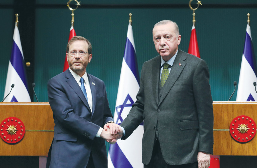  PRESIDENT ISAAC HERZOG and his Turkish counterpart, Recep Tayyip Erdogan, shake hands at a joint news conference in Ankara on Wednesday.  (photo credit: PRESIDENTIAL PRESS OFFICE/HANDOUT VIA REUTERS)