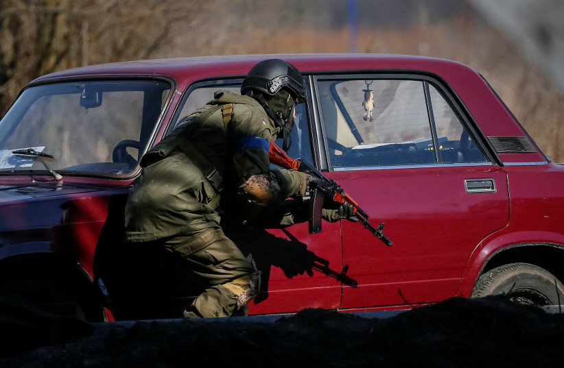  A member of the Ukrainian forces takes a position, amid Russia's invasion of Ukraine, in Irpin, Ukraine March 12, 2022.  (photo credit: REUTERS/GLEB GARANICH)