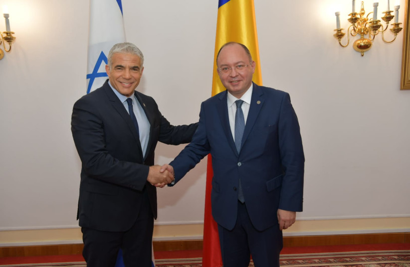   Israeli Foreign Minister Yair Lapid and Romanian Foreign Minister Bogdan Aurescu meeting in Romania, March 13, 2022 . (credit: SHLOMI AMSALEM/GPO)