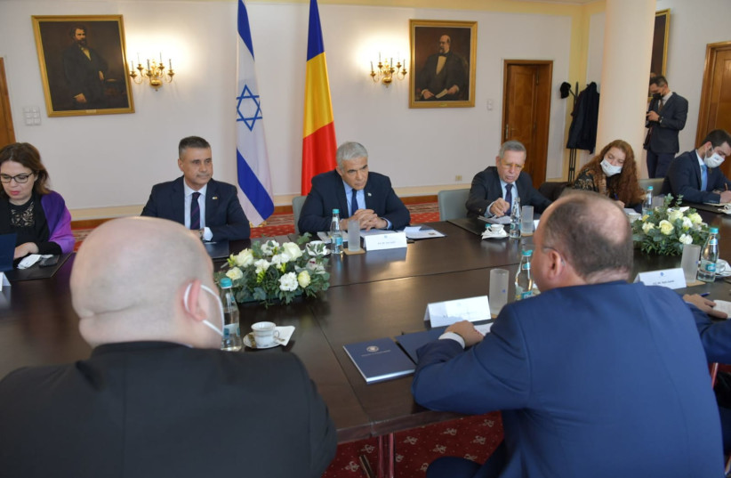   Israeli Foreign Minister Yair Lapid and Romanian Foreign Minister Bogdan Aurescu meeting in Romania, March 13, 2022. (credit: SHLOMI AMSALEM/GPO)