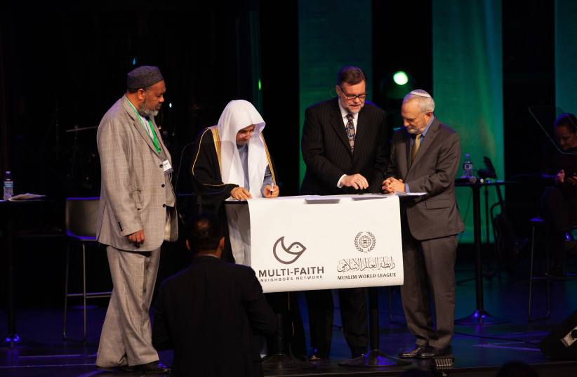  A group of faith representatives, including Rabbi David Saperstein, Imam Mohamad Magid and Pastor Bob Roberts, sign a letter of intent in support of the Charter of Makkah. (photo credit: Courtesy / ALL ISRAEL NEWS)