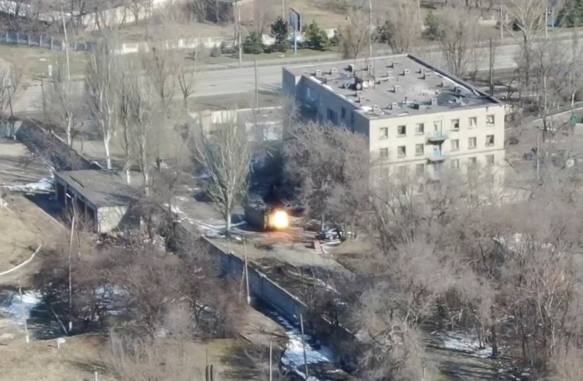  An aeriel view shows an military vehicle shoot rounds next to a building, as Russia's invasion of Ukraine continues, in Maripuol, Ukraine as uploaded on March 13, 2022, in this handout drone video obtained by Reuters on March 13, 2022. (credit: AZOV MARIUPOL/HANDOUT VIA REUTERS)