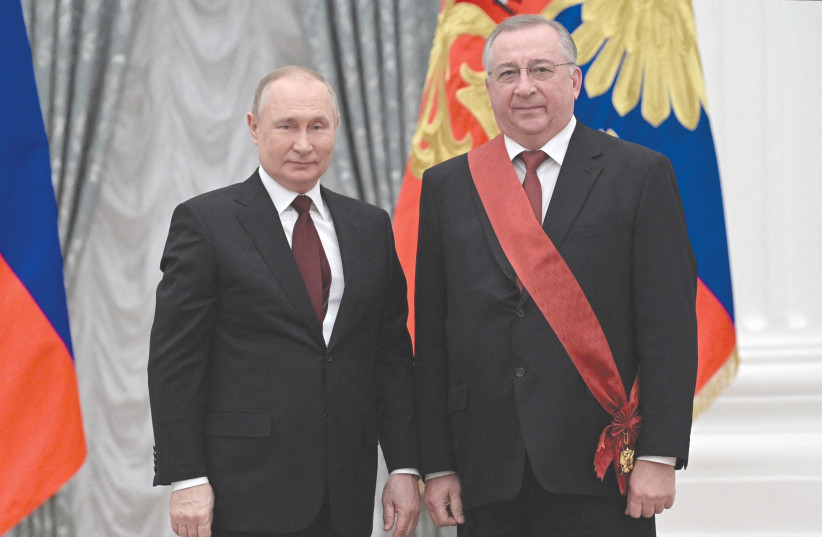  RUSSIAN PRESIDENT Vladimir Putin poses with Russian oil pipeline monopoly Transneft CEO Nikolai Tokarev, after the latter was awarded the title of Hero of Labor of the Russian Federation during a ceremony at the Kremlin last month. (photo credit: SPUTNIK/REUTERS)
