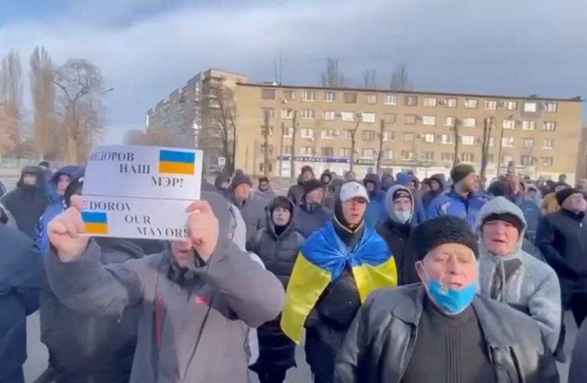  People protest the abduction of Mayor Ivan Fedorov, outside the Melitopol regional administration building, after he was reportedly taken away by Russian forces, during their ongoing invasion, in Melitopol, Ukraine in this still image obtained from handout video released March 12, 2022.  (credit: Courtesy of Deputy Head for President's Office, Ukraine/Handout via REUTERS)
