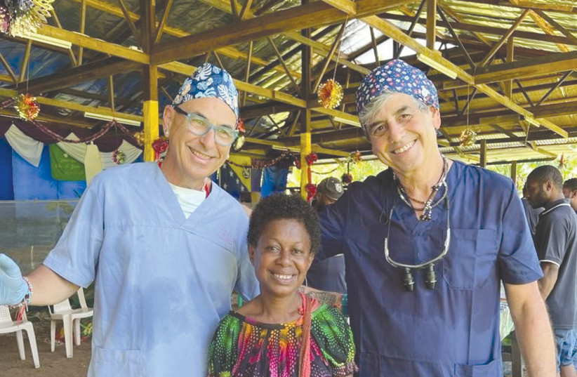  DORON KEREN (left) and Roni Amid with one of their New Guinea patients. (credit: DANIEL AMIT)