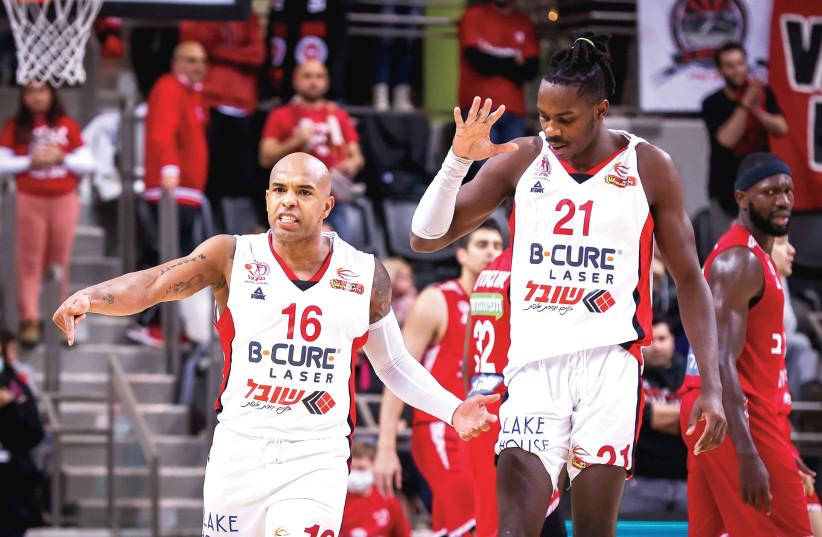  HAPOEL HAIFA’S Gregory Vargas (left) and James Dickey react after a big basket late in the fourth quarter of their 73-71 home victory over Hapoel Jerusalem (photo credit: MAOR ELKASLASI)