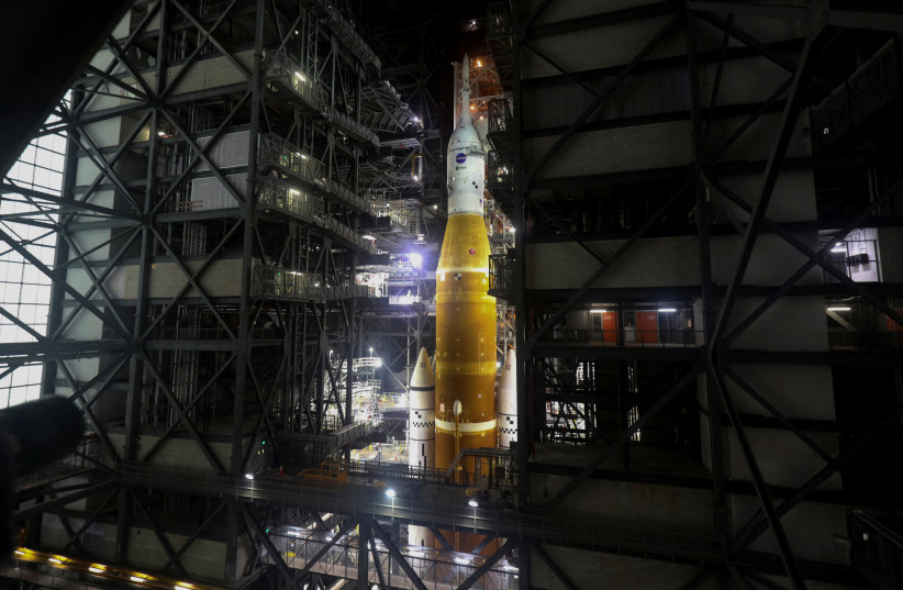 NASA's next-generation moon rocket, the Space Launch System (SLS) rocket with its Orion crew capsule perched on top, is seen in the Vehicle Assembly Building (VAB) before it is scheduled to make a slow-motion journey to its launch pad at Cape Canaveral, Florida, US, March 16, 2022. (credit: REUTERS/Thom Baur)