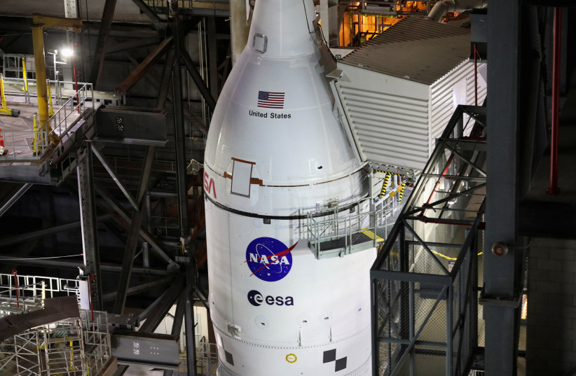 NASA's next-generation moon rocket, the Space Launch System (SLS) rocket with its Orion crew capsule perched on top, is seen in the Vehicle Assembly Building (VAB) before it is scheduled to make a slow-motion journey to its launch pad at Cape Canaveral, Florida, US, March 16, 2022. (credit: REUTERS/Thom Baur)