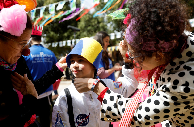  Artem, a Jewish Ukrainian refugee from the Alumim children's home in Zhytomyr, Ukraine, dresses up as part of celebrations of the Jewish holiday of Purim after arriving to Israel following Russia's invasion of Ukraine, at the Nes Harim Field and Forest Education Center in Nes Harim, March 2022 (credit: REUTERS/AMIR COHEN)