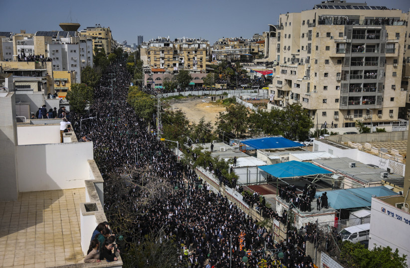 Ultra-Orthodox Jews gather during the funeral ceremony of Rabbi Chaim Kanievsky in the streets near the cemetery  in the city of Bnei Brak, on March 20, 2022 (photo credit: TOMER NEUBERG/FLASH90)