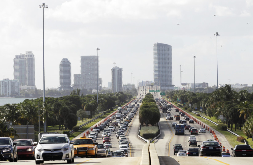  Traffic leading towards Art Basel on Miami Beach is seen with the skyline of midtown Miami in the background December 4, 2014.  (credit: COURTESY + REUTERS/JONATHAN ERNST + REUTERS/ANDREW INNERARITY)