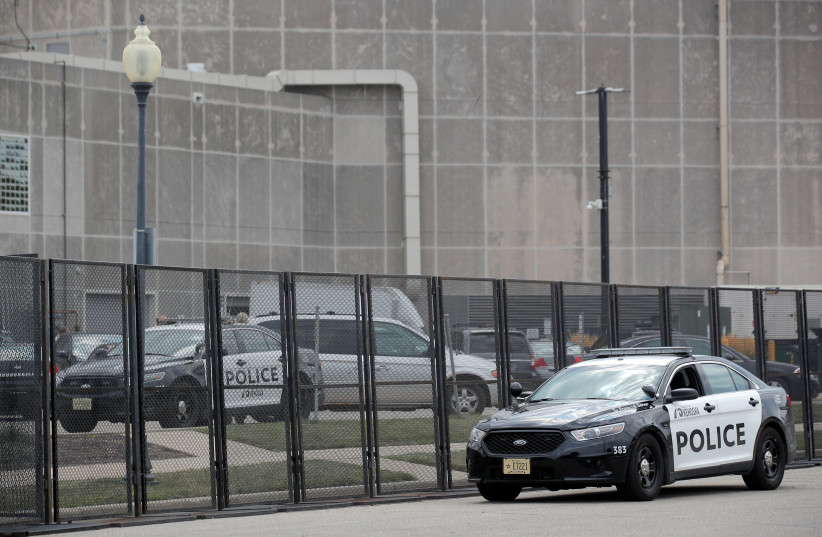  A Kenosha police vehicle is parked outside a defensive perimeter that has been erected around the Kenosha Municipal Building in response to the protests and shootings that came after Jacob Blake was shot by police, in Kenosha, Wisconsin, US, August 27, 2020 (photo credit: REUTERS/BRENDAN MCDERMID)