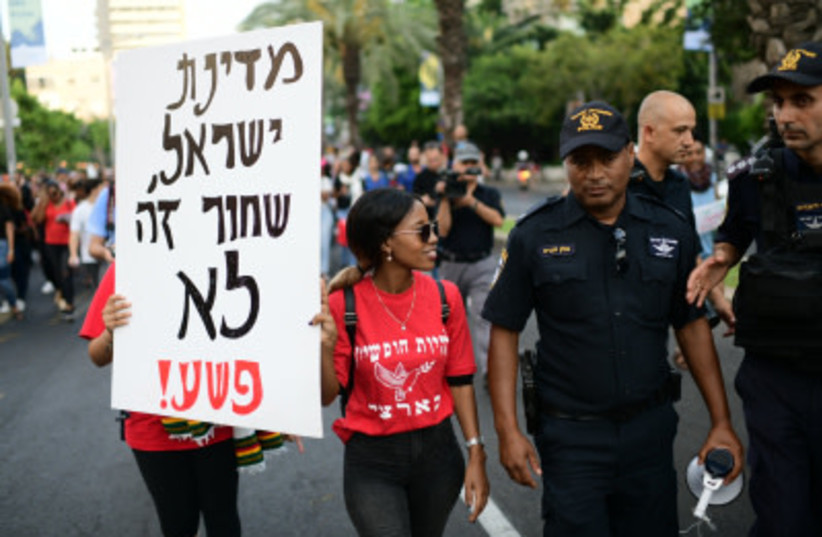 Ethiopian-Israelis and supporters take part in a protest against police violence and discrimination following the death of 19-year-old Ethiopian, Solomon Tekah who was shot and killed in Kiryat Haim by an off-duty police officer, in Tel Aviv, July 8, 2019 (photo credit: TOMER NEUBERG/FLASH90)