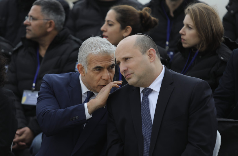  Prime Minister Naftali Bennett and Foreign Minister Yair Lapid at Ben-Gurion Airport to see off Israel's humanitarian delegation to Ukraine, March 21, 2022.  (photo credit: MARC ISRAEL SELLEM/THE JERUSALEM POST)