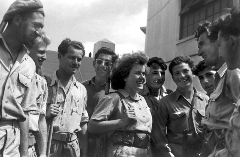  THE DAY after the State of Israel is declared in May 1948, a group of Hagana fighters, including a woman, celebrates after taking control of Jaffa. (photo credit: REUTERS)