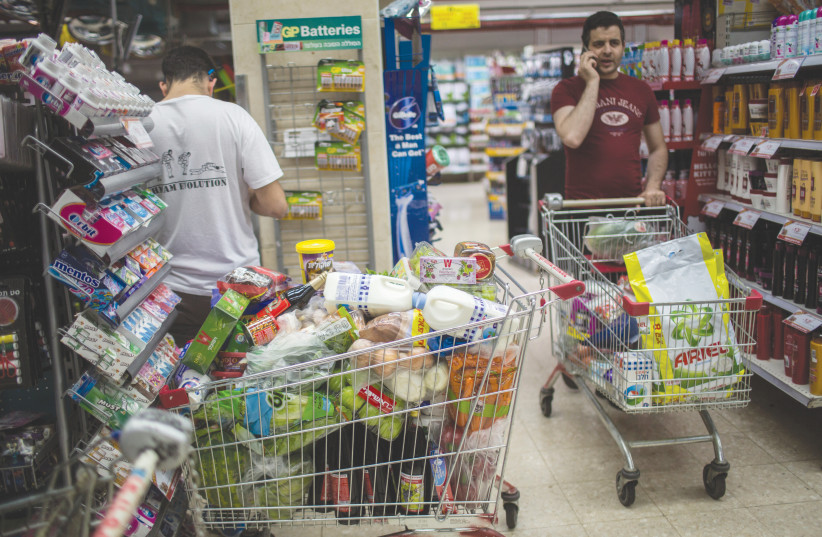  SHOPPERS STOCKING up at a Jerusalem supermarket before the Passover holiday. (credit: HADAS PARUSH/FLASH90)