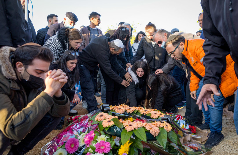  Mourners attend the funeral of 49-year-old Doris Yahavas, who was murdered at yesterday deadly terror attack, at the cemetery in Moshav Gilat, March 23, 2022.  (photo credit: FLASH90)