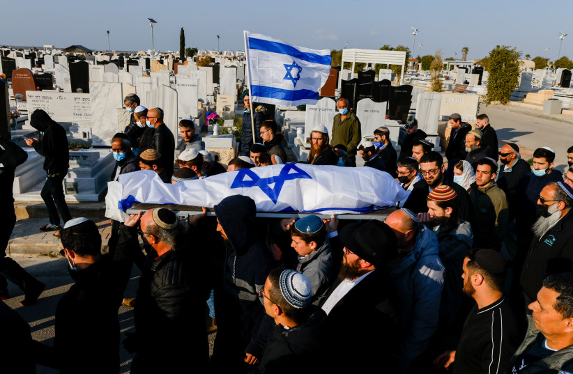  Mourners carry the body of 67-year-old Menahem Yehezkel, who was murdered at yesterday deadly terror attack, during his funeral at the cemetery in Beer Sheva, southern Israel, on March 23, 2022. (credit: OLIVIER FITOUSSI/FLASH90)