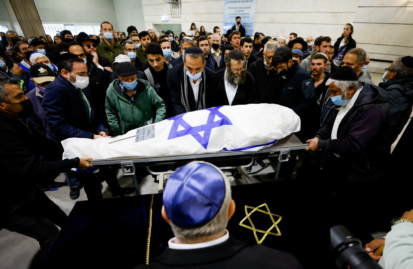  Mourners carry the body of 67-year-old Menahem Yehezkel, who was murdered at yesterday deadly terror attack, during his funeral at the cemetery in Beer Sheva, southern Israel, on March 23, 2022. (photo credit: OLIVIER FITOUSSI/FLASH90)