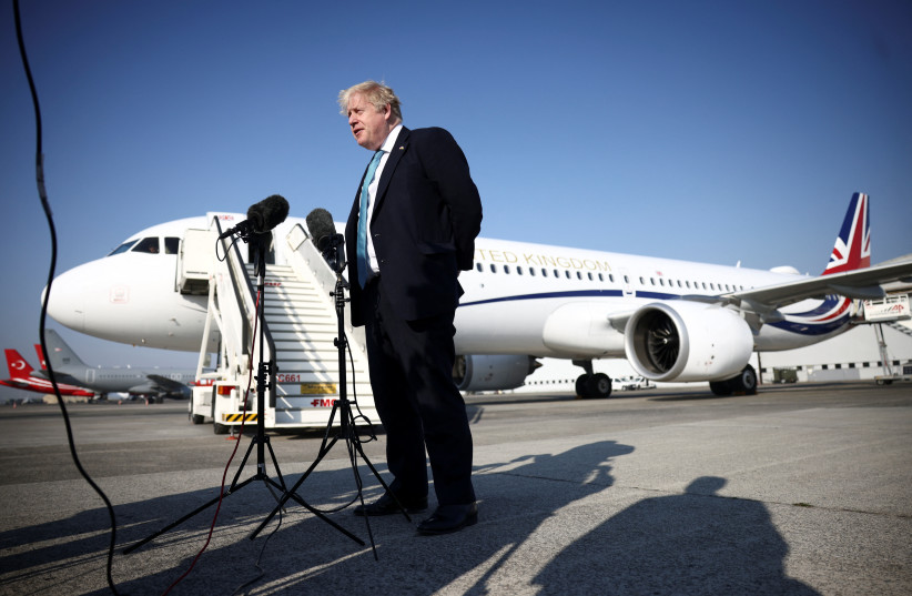  British Prime Minister Boris Johnson addresses the media as he arrives to take part in a NATO summit to discuss Russia's invasion of Ukraine, in Brussels, Belgium March 24, 2022. (photo credit: REUTERS/HENRY NICHOLLS)