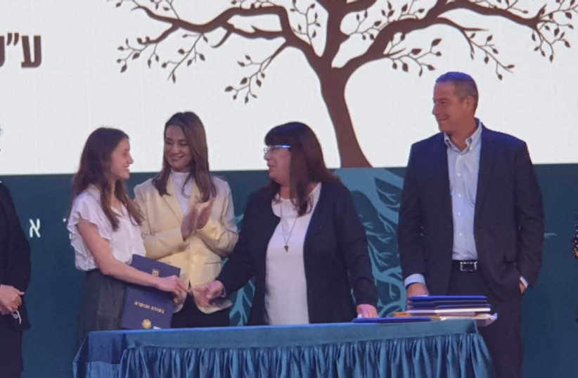  ORIYA ACCEPTING her award, with Education Minister Yifat Shasha-Biton and Dr. Tzvia Riven, Elad’s mother. (photo credit: BARBARA SOFER)