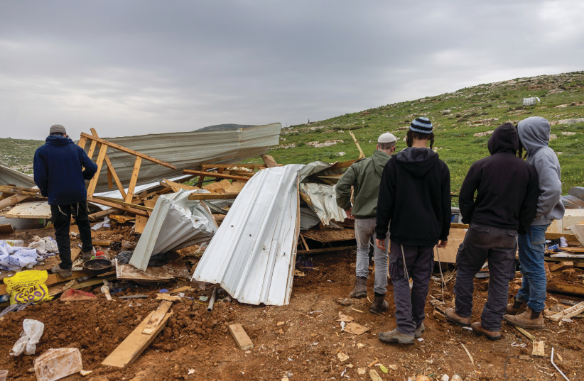  GATHERING AROUND damaged structures after Israeli security forces demolished Maoz Esther, March 21. (photo credit: YONATAN SINDEL/FLASH90)