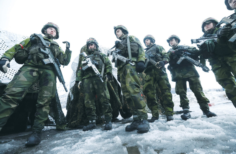  SWEDISH SOLDIERS take part in a military exercise called Cold Response 2022 in Evenes, Norway this week, gathering some 30,000 troops from NATO countries, plus Finland and Sweden, amid Russia’s invasion of Ukraine.  (photo credit: YVES HERMAN/REUTERS)