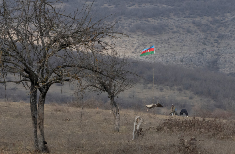  An Azeri soldier is seen at fighting positions near divided Taghavard village in Nagorno-Karabakh region (photo credit: REUTERS)