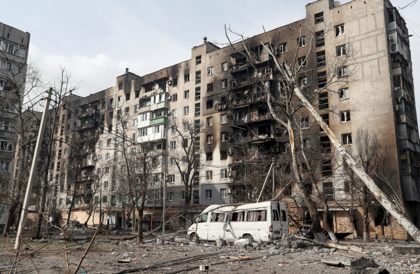 A view shows an apartment building destroyed in the course of Ukraine-Russia conflict in the besieged southern port city of Mariupol, Ukraine March 25, 2022. (photo credit: REUTERS/ALEXANDER ERMOCHENKO)