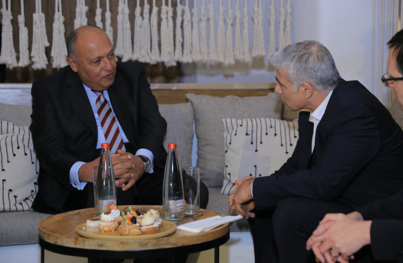  Foreign Minister Yair Lapid speaks with Egyptian foreign minister Sameh Shoukry during the Negev Summit on March 27, 2022 (credit: ASSI EFRATI/GPO, BOAZ OPPENHEIM/GPO)