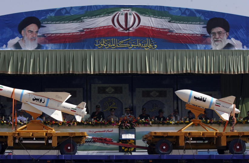 A military vehicle carrying Iranian Zoobin smart bomb (L) and Sagheb missile under pictures of Iran's Supreme Leader Ayatollah Ali Khamenei (R) and Late Leader Ayatollah Ruhollah Khomeini during a parade to commemorate the anniversary of the Iran-Iraq war (1980-88), in Tehran September 22, 2011. (photo credit: REUTERS/STRINGER)