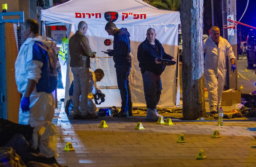 Israeli security forces inspect the scene of a shooting attack in Hadera, March 27, 2022. (photo credit: FLASH90)