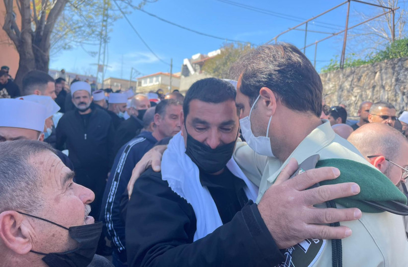  OC Border Police Amir Cohen comforts Ravia Falah, the father of Border Policeman Yezen Falah who was killed in a terrorist shooting attack in Hadera on March 28, 2022. (credit: POLICE SPOKESPERSON'S UNIT)