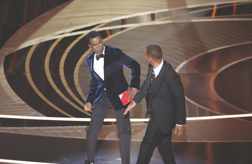  Will Smith (right) strikes Chris Rock onstage during the Academy Awards ceremony on Sunday. (photo credit: Myung Chun/Los Angeles Times/TNS)