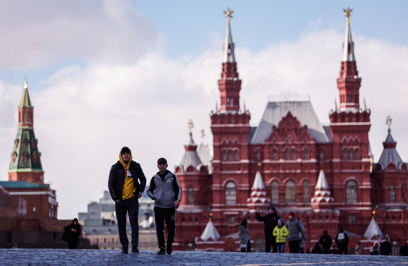 People walk at the Red Square on a sunny day in Moscow, Russia March 30, 2022. (photo credit: MAXIM SHEMETOV/REUTERS)