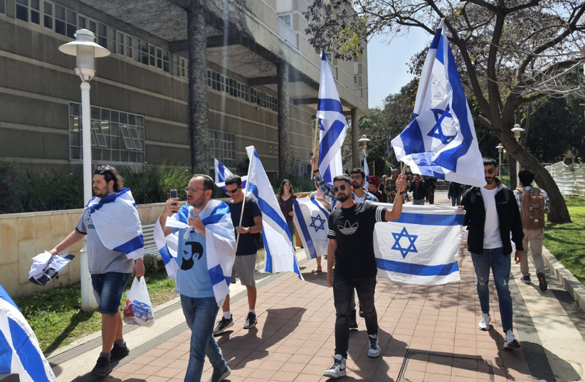  Im Tirtzu student activists are seen waving Israeli flags in protest at Bar-Ilan University. (photo credit: IM TIRTZU)