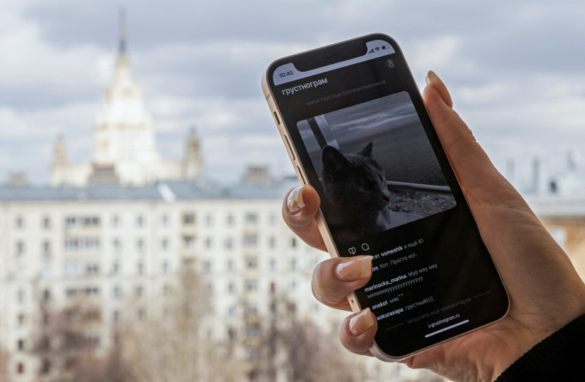 A web page of the social network 'Grustnogram' is seen on a smartphone in this illustration taken March 30, 2022. (photo credit: REUTERS/REUTERS PHOTOGRAPHER/ILLUSTRATION)