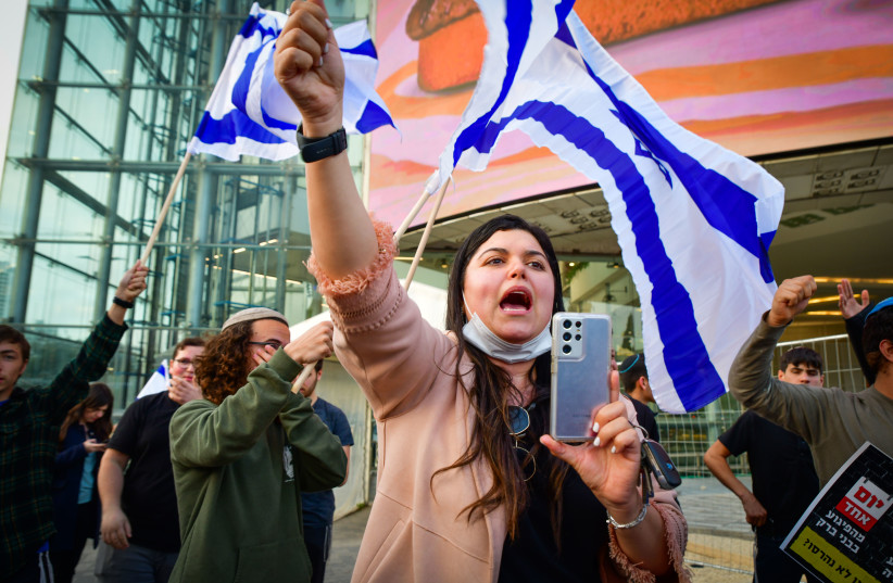  Israelis wave flags as they protest against recent terrorist attacks outside Hakirya Base in Tel Aviv, on March 30, 2022.  (photo credit: AVSHALOM SASSONI/FLASH90)