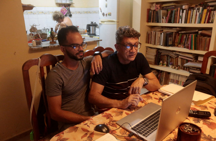  Playwright Eberto Garcia Abreuin and theatrical producer Felix Ortiz Ramos are seen at their home during an interview with Reuters in Havana, Cuba, March 28, 2022 (photo credit: REUTERS/STRINGER)