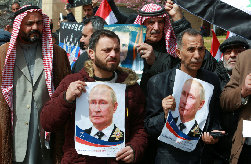  Lebanese and Syrian protesters hold posters of Russian President Vladimir Putin in front of UN headquarters in Beirut, during a rally on March 20 in support of Russia’s military invasion of Ukraine. (photo credit: AZIZ TAHER/REUTERS)