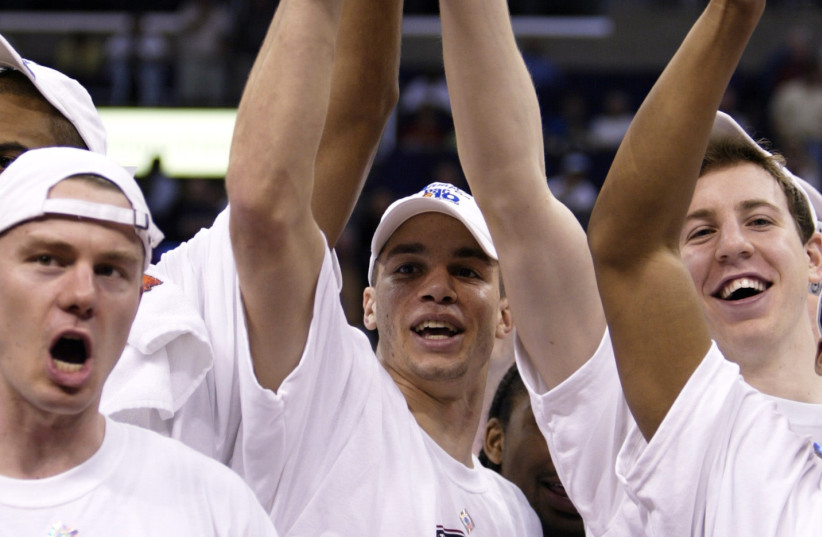  STANFORD PLAYERS (L-R) Matt Lottich, Nick Robinson and Dan Grunfeld celebrate winning the Pac-10 Conference Men’s Basketball Tournament in Los Angeles, 2004. (photo credit: Lucy Nicholson/Reuters)